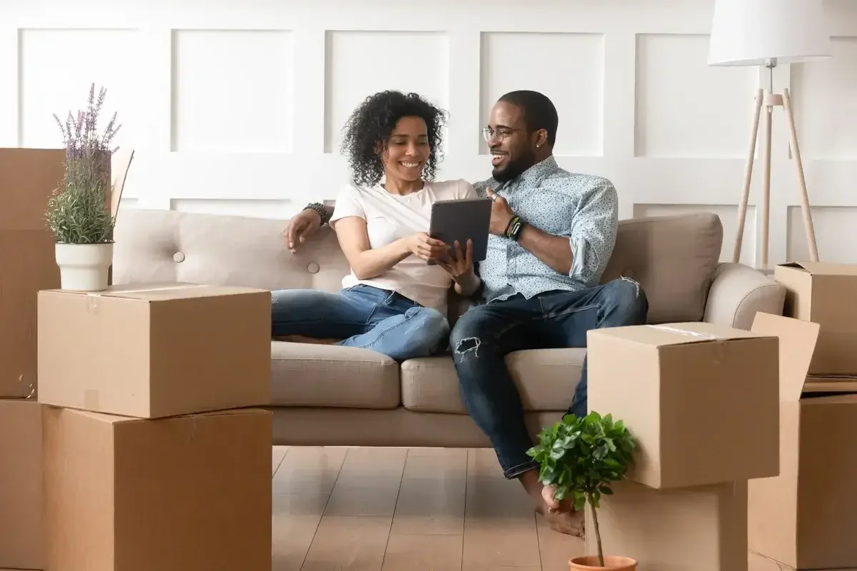 Couple reviewing tablet with information to sell their home
