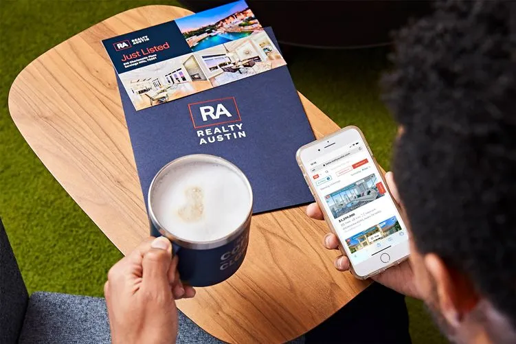 Realty Austin folder on a table